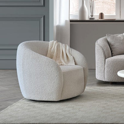 Modern beige armchair in a living room setting with a neutral color palette.